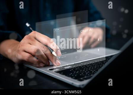 User interacts with AI chatbot interface on laptop, symbolizing future of communication, digital assistance, and smart technology integrating artifici Stock Photo