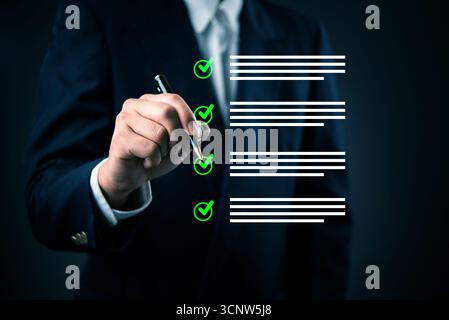 Man in suit completing virtual checklist, business success, goal accomplishment. Concepts task management, quality assurance, strategic planning, corp Stock Photo