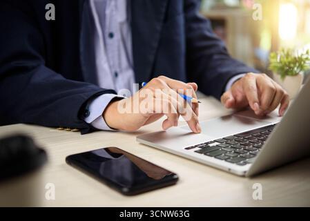Businessman using computer laptop in modern office. business strategy planning, analysis, and corporate productivity online working. Stock Photo