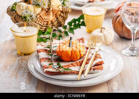 Place setting for Thanksgiving and autumn with pumpkins and autumn fruits Stock Photo