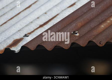 Close-up of a rusty, corrugated metal roof with brown and gray textures, Gazipur, bangladesh Stock Photo