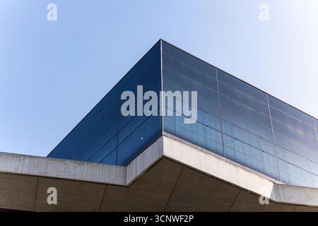 Modern architectural design features a blend of sleek glass panels and sturdy concrete structures, showcasing elegant lines and minimalist aesthetics Stock Photo