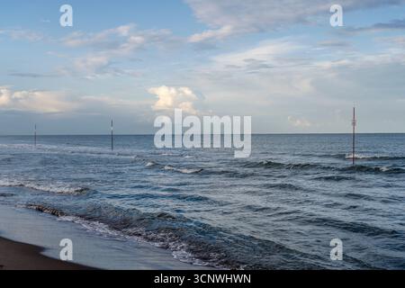 little waves on  Adriatic sandy beach under cloudy sky, shot in summer thunderstorm light at Rosolina Mare, Veneto, Italy Stock Photo