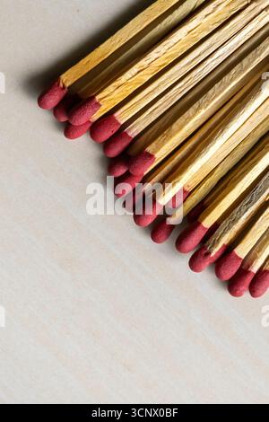 Match sticks on a wooden textured background. Matchsticks are very useful for starting a fire, lighting a candle, burning paper, etc. Stock Photo