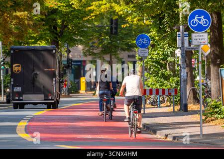 Colour-coded cycle path on a public road Stock Photo - Alamy