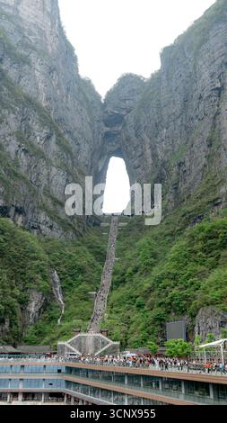 Crowds ascend the 999-step Stairway to Heaven toward Tianmen Cave, or Heaven’s Gate, in Zhangjiajie, China. This scenic area, Tianmen Dongkai, sits at Stock Photo