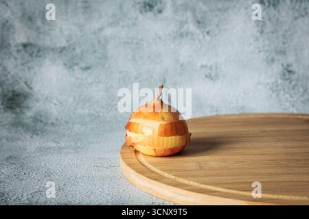 Creative concept of sliced yellow onion stacked in layers on wooden board, with natural light and minimalist background. Fresh, rustic, and quirky kit Stock Photo