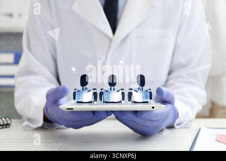Artificial intelligence medical assistant. Healthcare worker holding tablet computer, closeup. Virtual screen with robots above device Stock Photo