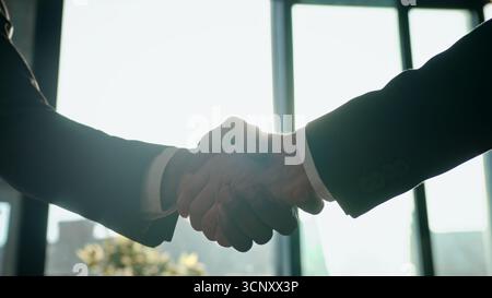 Close up male hands multiracial business men diversity ethnic businessmen team working handshaking cooperation partnership unity Caucasian African Stock Photo