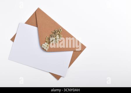 Brown kraft paper envelope decorated with dried flowers isolated on ...