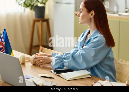 Red-haired language teacher engages students online while working from her comfortable home setting. Stock Photo