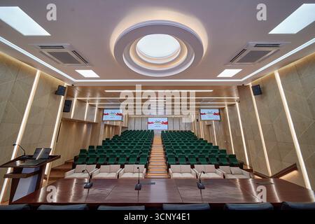 Modern Auditorium with Tiered Seating and a Circular Skylight Stock Photo