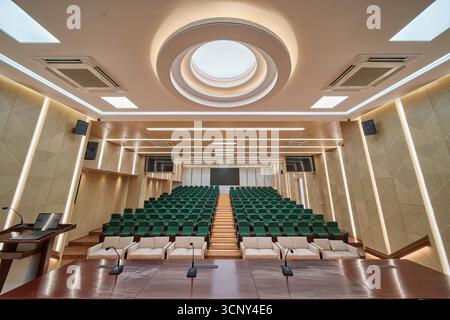 Modern Auditorium with Tiered Seating and a Circular Skylight Stock Photo