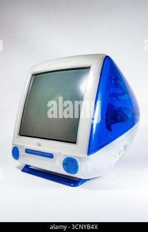 Retro Bondi blue and white Apple iMac G3 personal computer from the late 1990s against a white background highlighting its iconic design Stock Photo