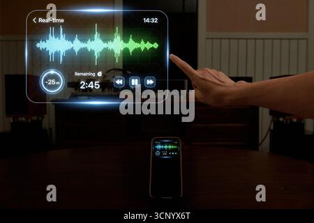 Close up of a finger interacting with a holographic sound wave interface. A concept for voice command, AI assistants, audio editing, podcasting, and m Stock Photo