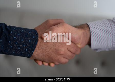 Business handshake between two professionals representing agreement, mutual trust, leadership and success.  Stock Photo