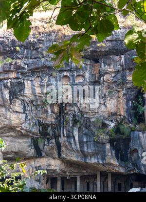 Ancient Caves Carved into Textured Rock Cliff Stock Photo - Alamy