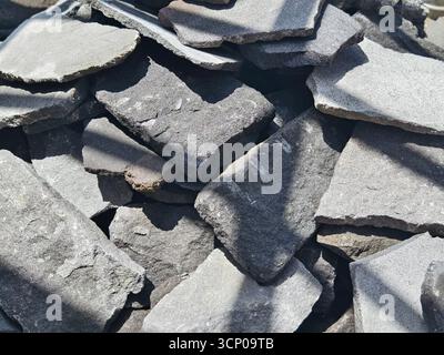 A stacked pile of natural stone slabs for wall cladding and construction materials Stock Photo