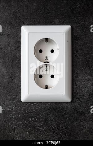 White, plastic, European double power outlet socket. Wall mounted, close up shot, no people Stock Photo