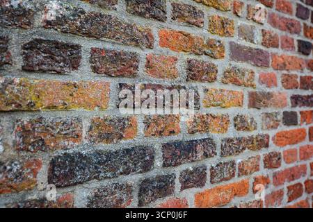 Old, weathered, colorful brick wall pattern or background. Front view, close up, no people Stock Photo