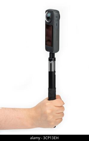 Hand hold 360 vr camera on selfie stick isolated on white studio background Stock Photo