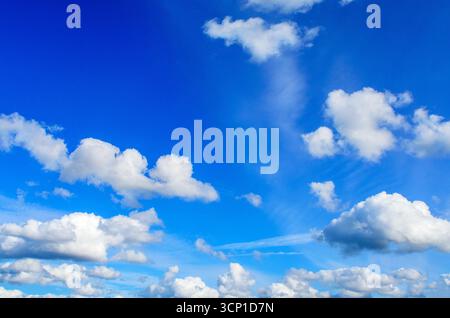 Beautiful blue sky with many white cumulus clouds in daylight Stock Photo