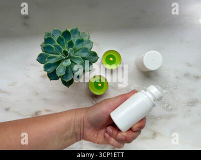 White roll-on deodorant mockup with succulent plant and tealight candles Stock Photo