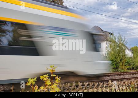 Fast moving train speed motion blurred railway transportation travel commute Stock Photo