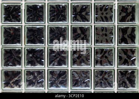 Glass block, glass brick wall with greenish tint. Stock Photo