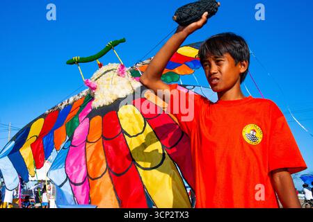 A boy holding a big bird kite during a kite festival in Cebu, Philippines Stock Photo