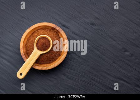 Dry instant ground coffee in a bowl and scoop - Coffea Stock Photo