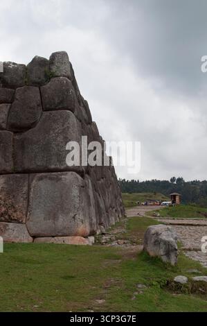 Ruins and stone wall at Sacsayhuamán, an Inca fortress in Cusco. Built with stones of different shapes and sizes that fit together perfectly. Stock Photo