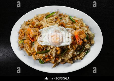 Special Mixed Fried Rice with Prawns, Chicken, Cashews, and a Sunny-Side Up Egg Stock Photo