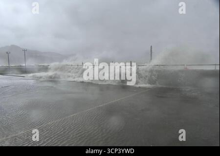 Signals Ragasa Waves splashing onto a promenade flooding the area at Heng Fa Chuen as ...