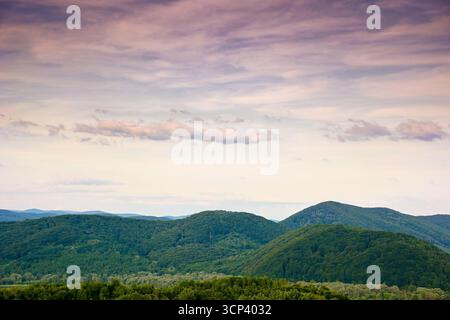 mountain landscape under evening sky with dramatic clouds. beautiful carpathian countryside scenery in summer. picturesque view Stock Photo