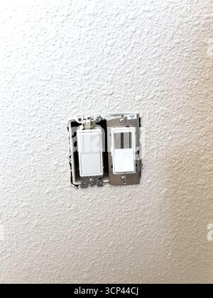 Uncovered Light Switch on Painted Wall Stock Photo