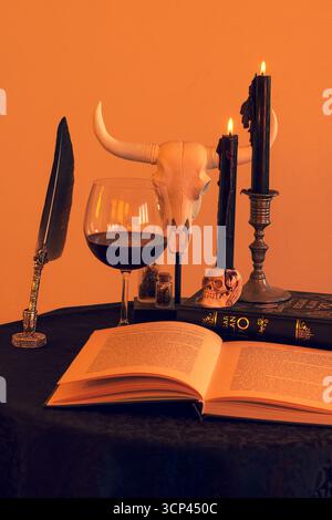 Scary still life with old books, skull and candles Stock Photo