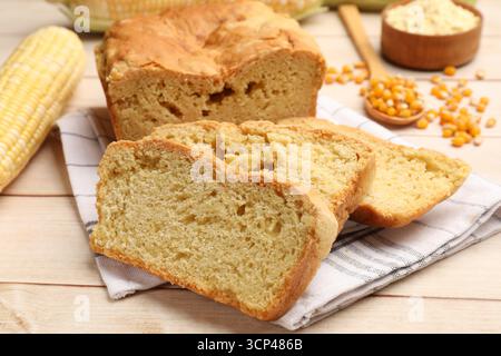 Freshly baked cornbread, cobs and seeds on wooden table, closeup Stock Photo