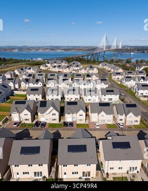 Aerial view from drone of houses with solar panels on roof in new housing estate development at South Queensferry, Scotland, UK Stock Photo