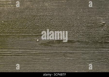 A wooden surface with a grainy texture. The wood appears to be old and weathered, giving it a rustic and natural feel. The surface is covered in a lay Stock Photo
