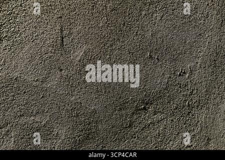 A close up of a dark carpet with a lot of texture. The carpet is black and has a lot of small, irregular shapes Stock Photo