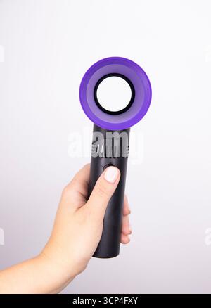 A handheld colorful fan on a white background. fan for makeup Stock Photo