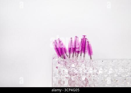 Makeup artist eyelash and eyebrow care tools. On a white background Brushes for eyelash extensions and eyebrow staining and next to the place for an a Stock Photo