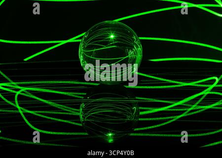 Glowing Glass Orb with Laser Lights Running Through It Stock Photo