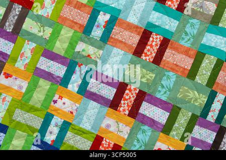 A patchwork quilt with many different colored squares. Abstract background Stock Photo