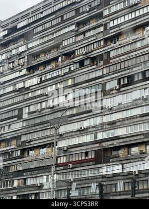 Monochrome City Facade Of A Dense Apartment Building With Balconies And Windows expansive high-rise apartment block with rows of balconies Stock Photo