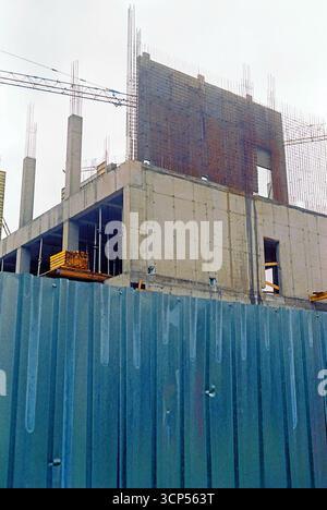 Analog archive photo of a construction site from the outside, showing fences, formwork, concrete, and reinforcement structures. Stock Photo