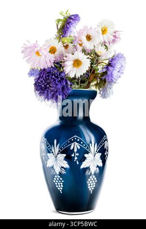 Wild daisy and chrysanthemum flowers bunch in large glass blue vase isolated over white Stock Photo