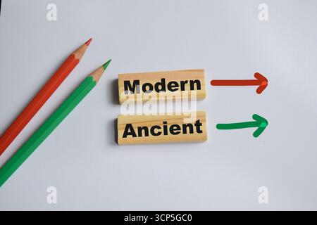Modern and ancient on stacked wooden cubes on the table. Symbolizing contrast and cultural evolution. Business and finance concept Stock Photo