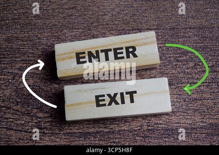 Enter and exit on stacked wooden cubes on the table. Symbolizing access and planning. Business and finance concept Stock Photo